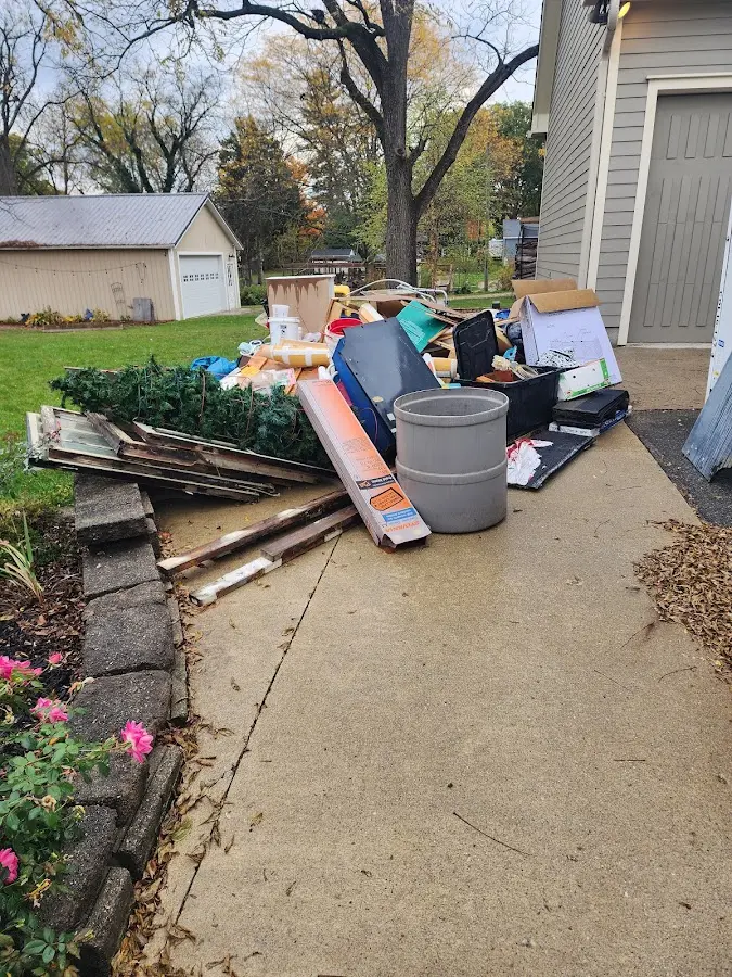 Dumpster being loaded with debris for Estate Cleanout Dumpster Rental in East Hartford